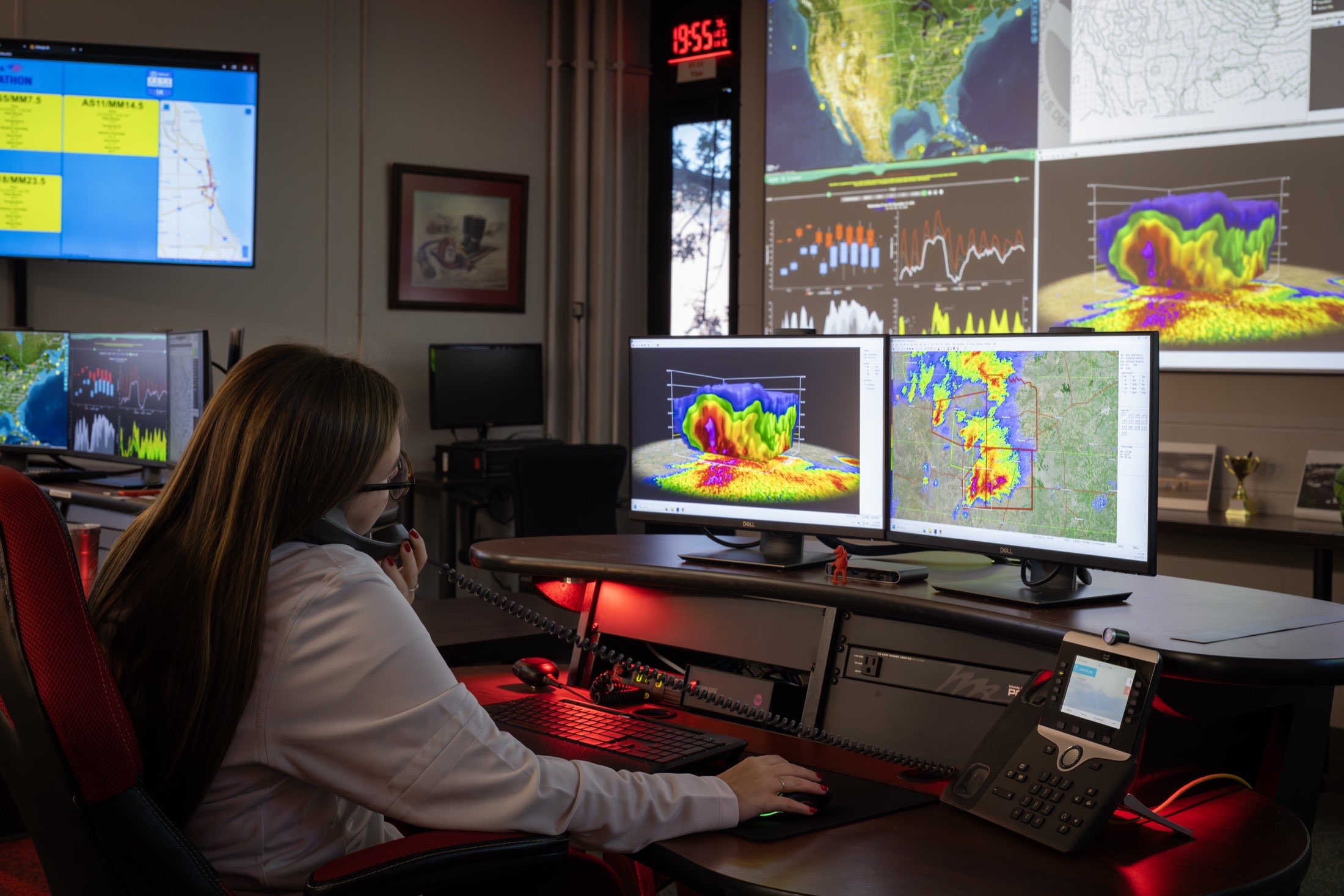 Students working severe weather at multi-monitor forecast workstations in the DSOC Intelligence Operations Unit