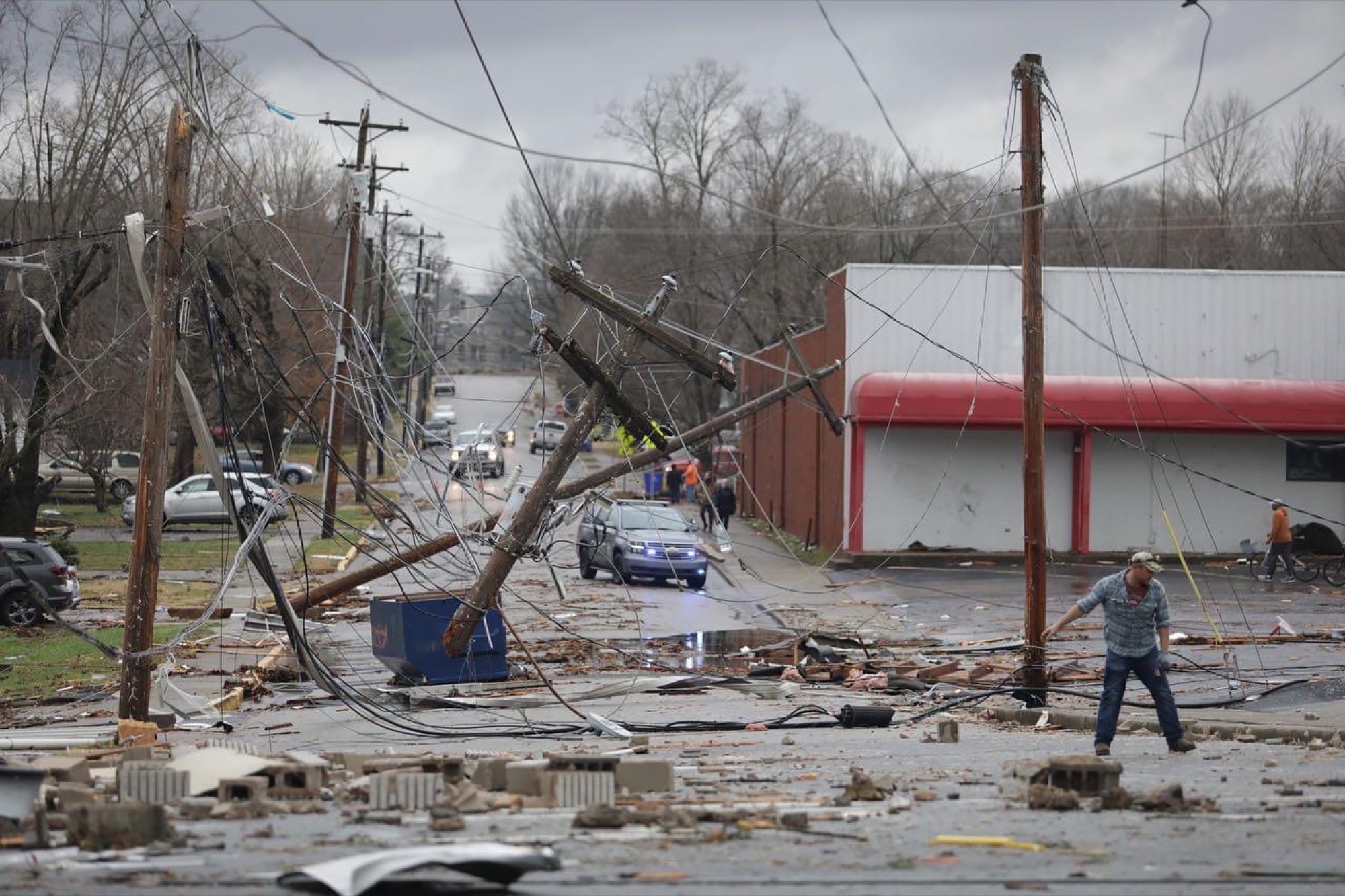 Tornado damage in Bowling Green on December 11, 2021: downed power poles and debris across a city street