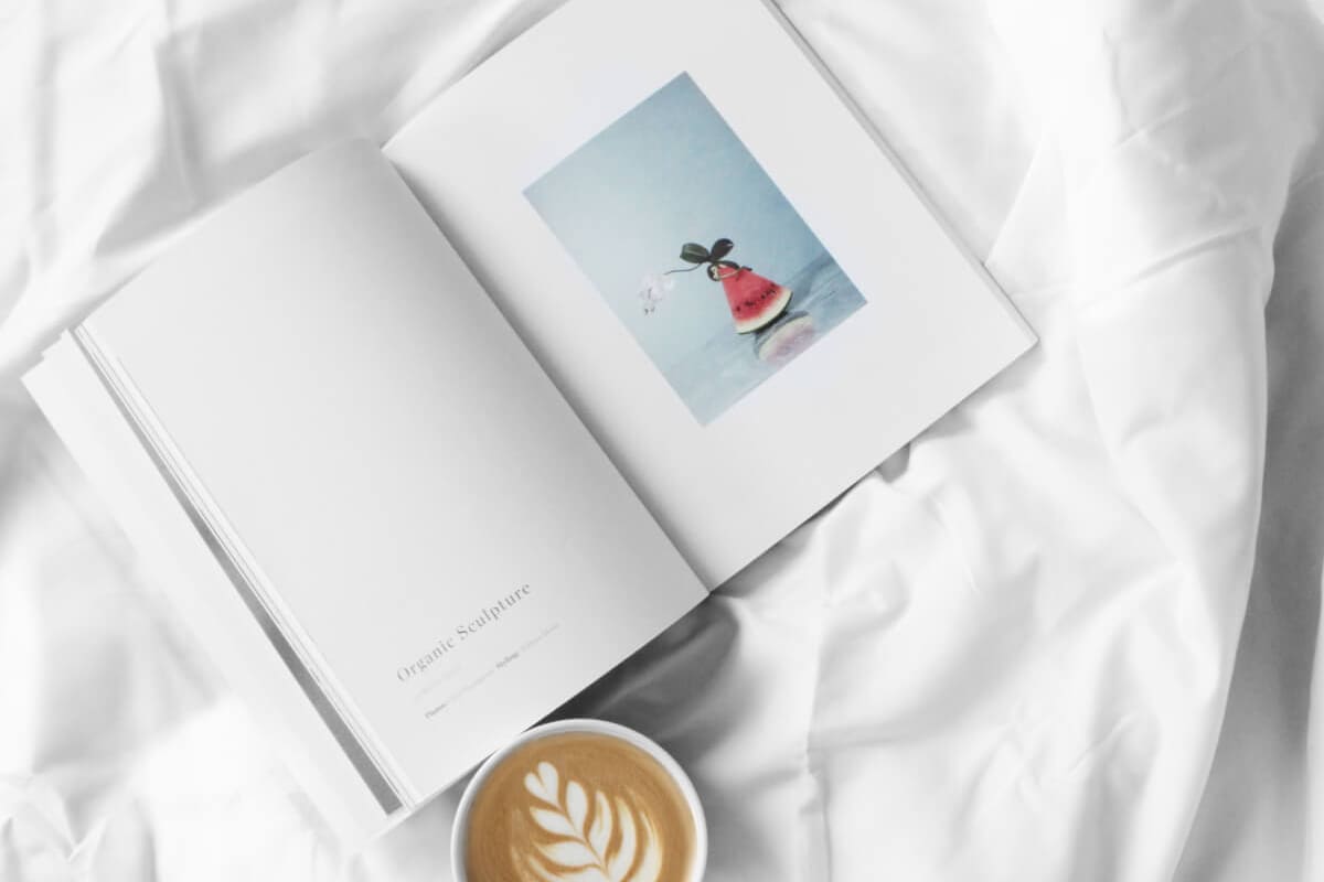 Open Book with Coffee on White Sheets Open Book with Coffee on White Sheets